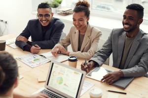 Team collaborating in an office, highlighting Managed IT Services, IT support, and solutions like network security, data backup, and system monitoring for businesses in Terre Haute and Plainfield, IN.